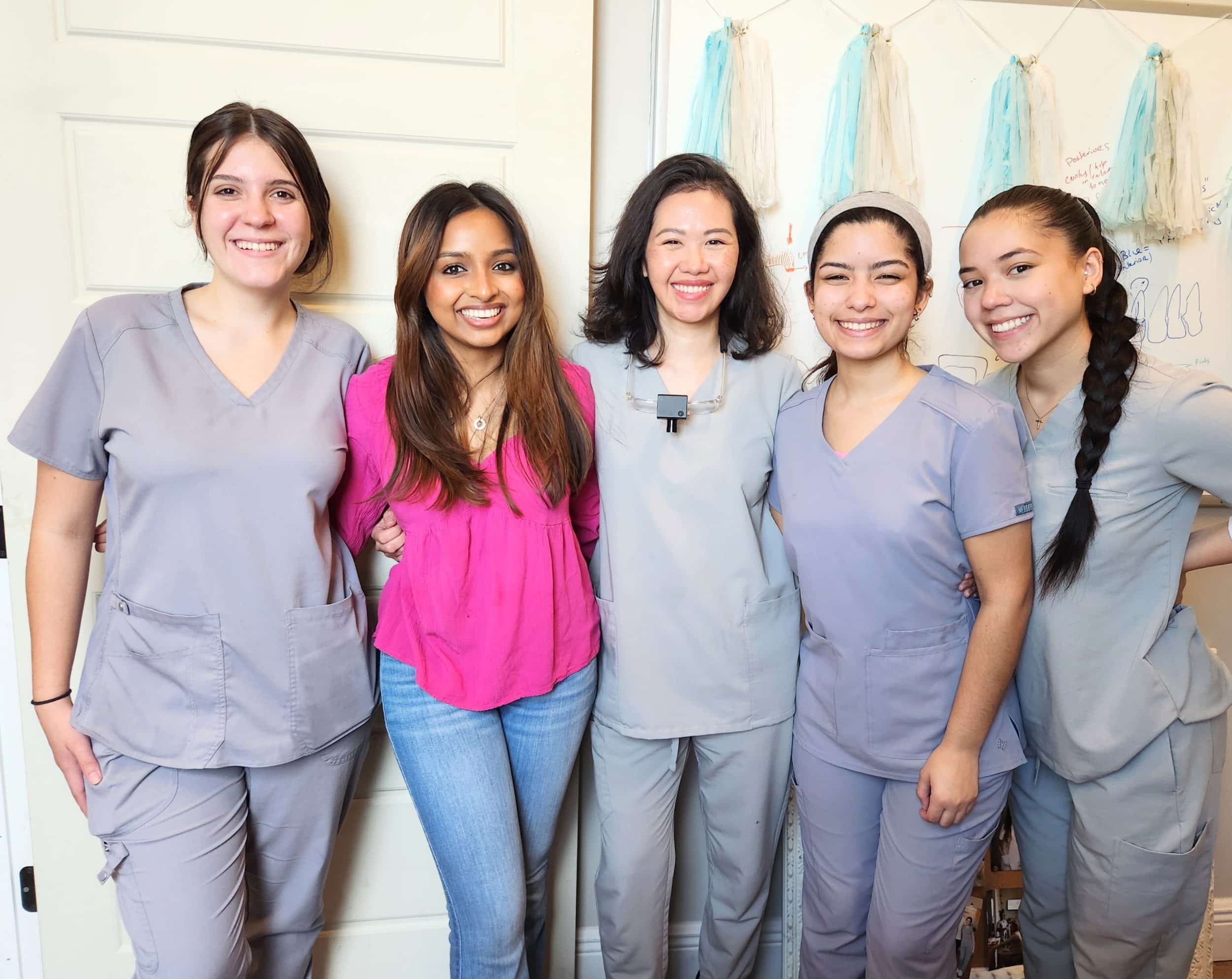 Group photo of medical professionals smiling.